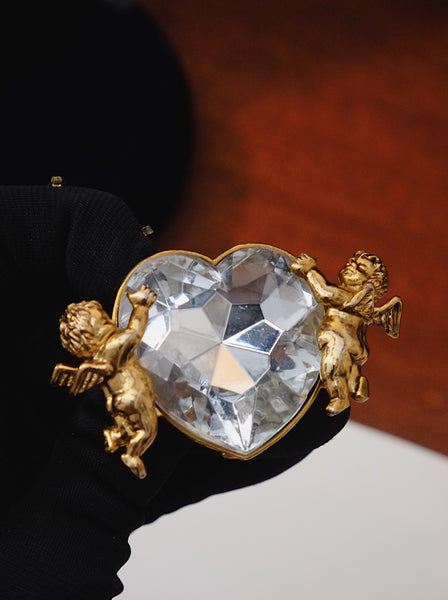 Moschino angels holding a heart brooch