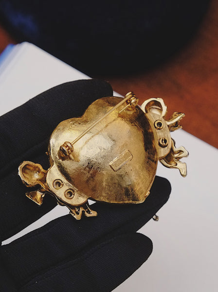 Moschino angels holding a heart brooch