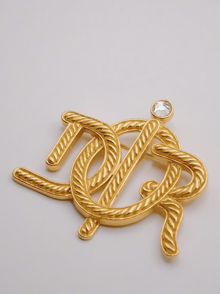 Pre-owned vintage Christian Dior logo brooch | on slowness