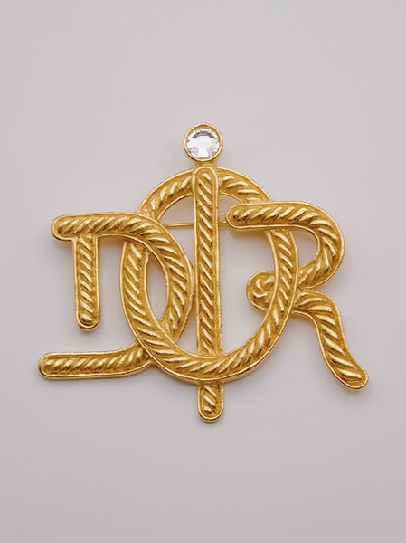 Pre-owned vintage Christian Dior logo brooch | on slowness